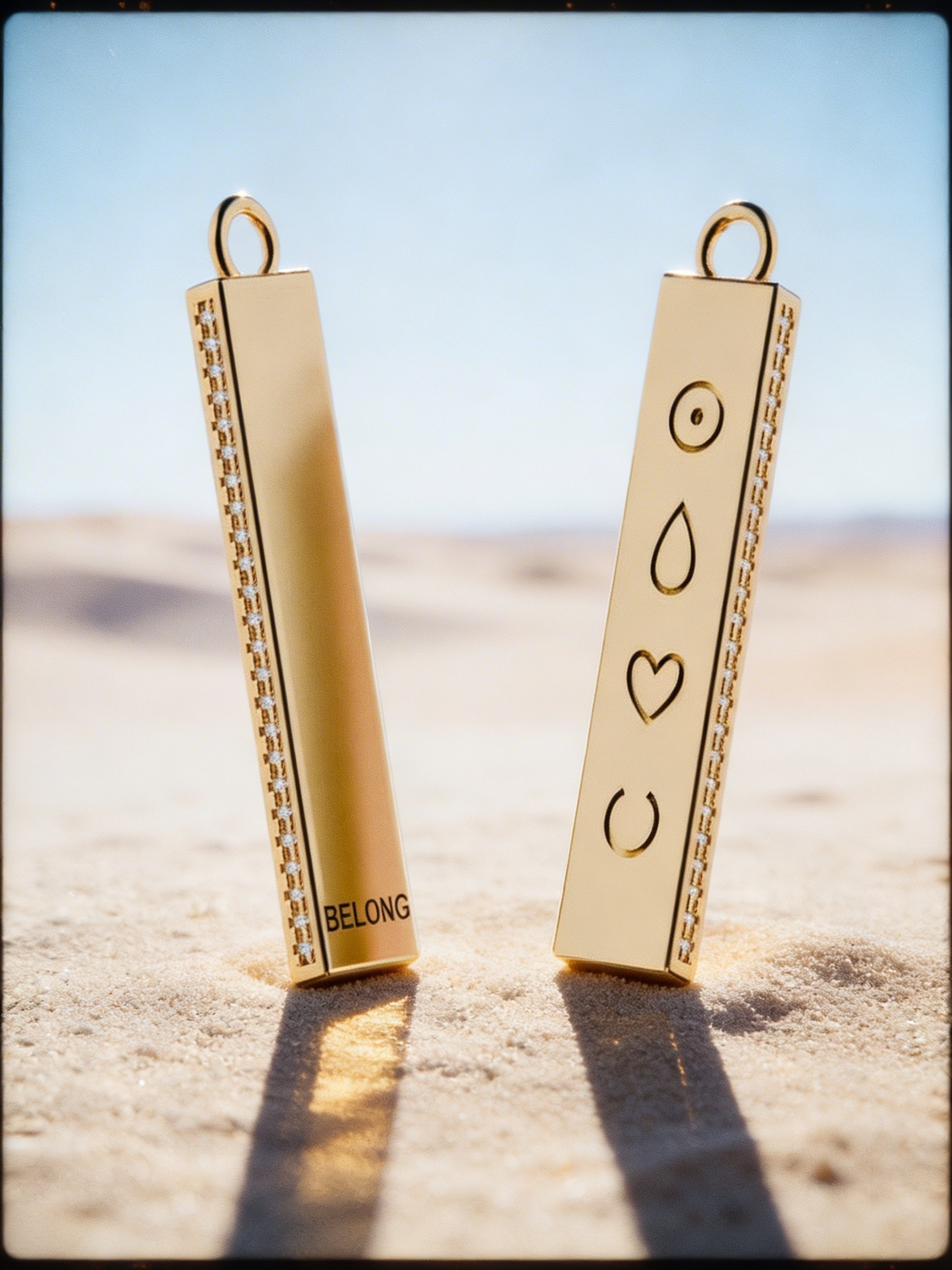 Two BELONG pendants with the four symbols in the desert