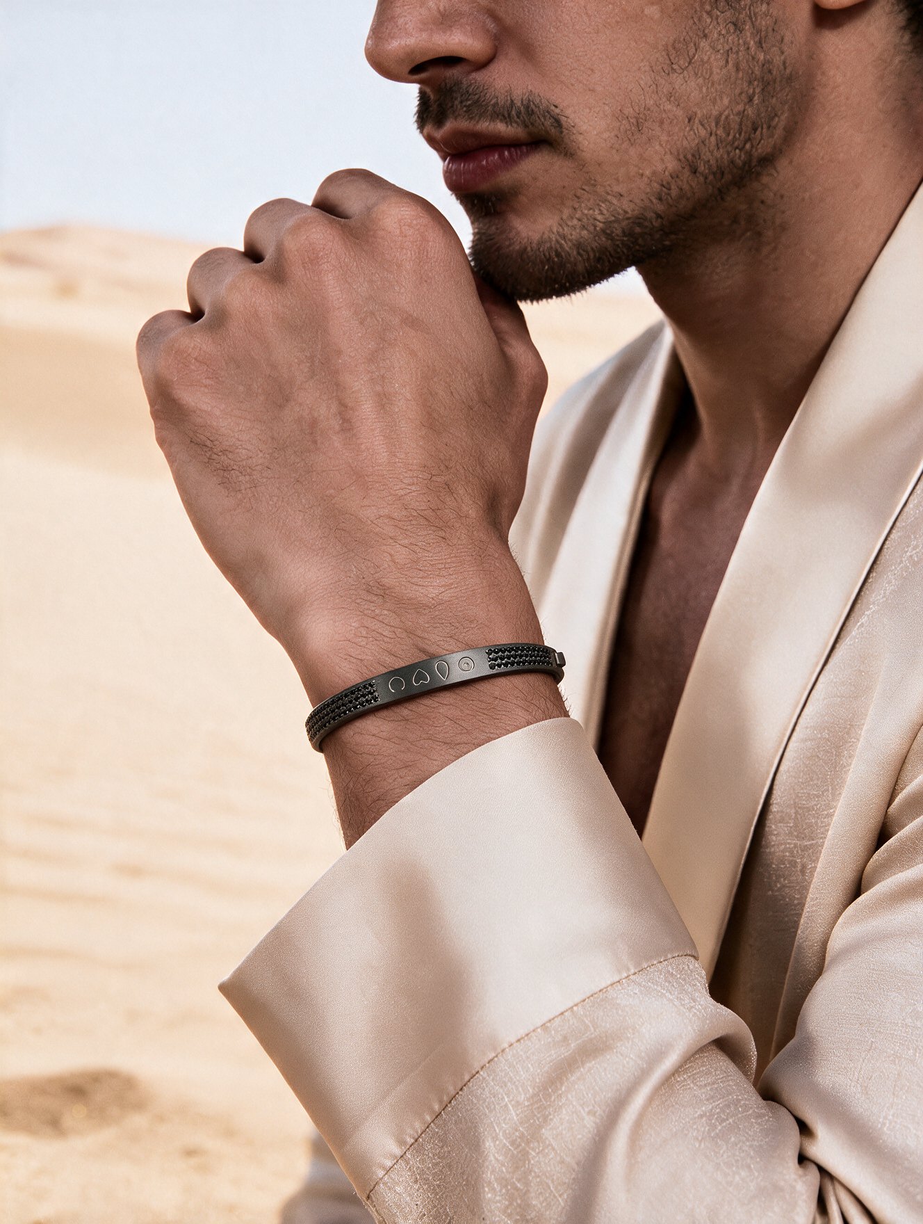 Man wearing a black BELONG bracelet